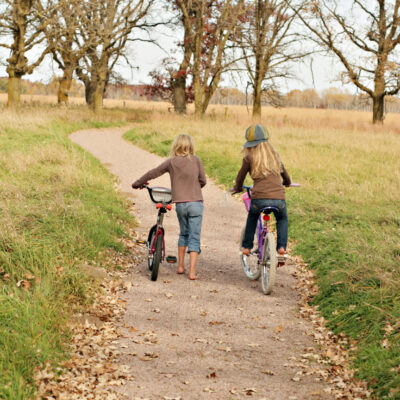 Children bicycle at the Crane Meadows National Wildlife Refuge enjoying outdoor recreation.