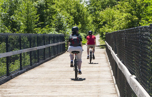 Biking across a bridge on the Soo Line Trail